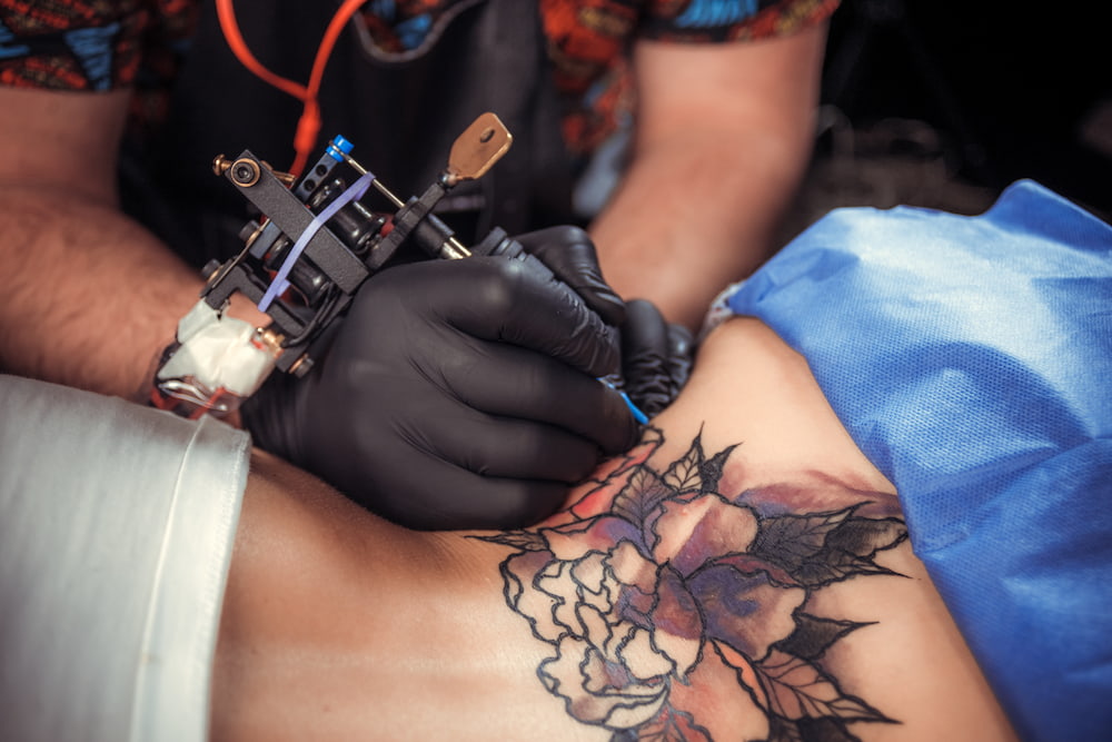 A man tattooing over stretch marks